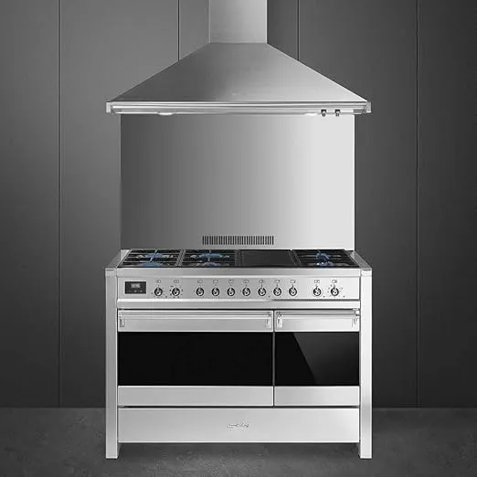 Smeg dual fuel cooker with stainless steel oven and cooktop.