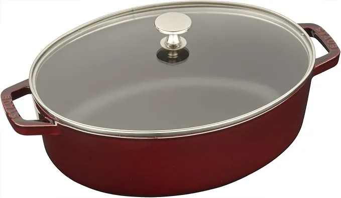 Staub cast iron shallow oval cocotte, 3.8L capacity, with glass lid.
