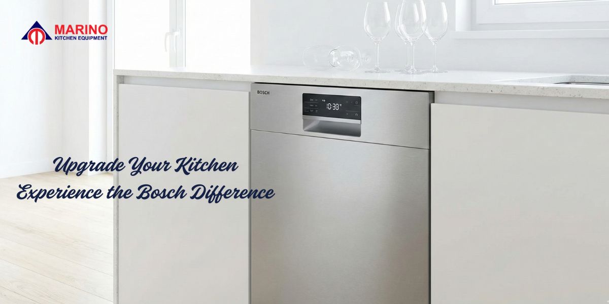 A sleek stainless steel built-in dishwasher machine installed in a luxury modern kitchen with wine glasses on the counter.